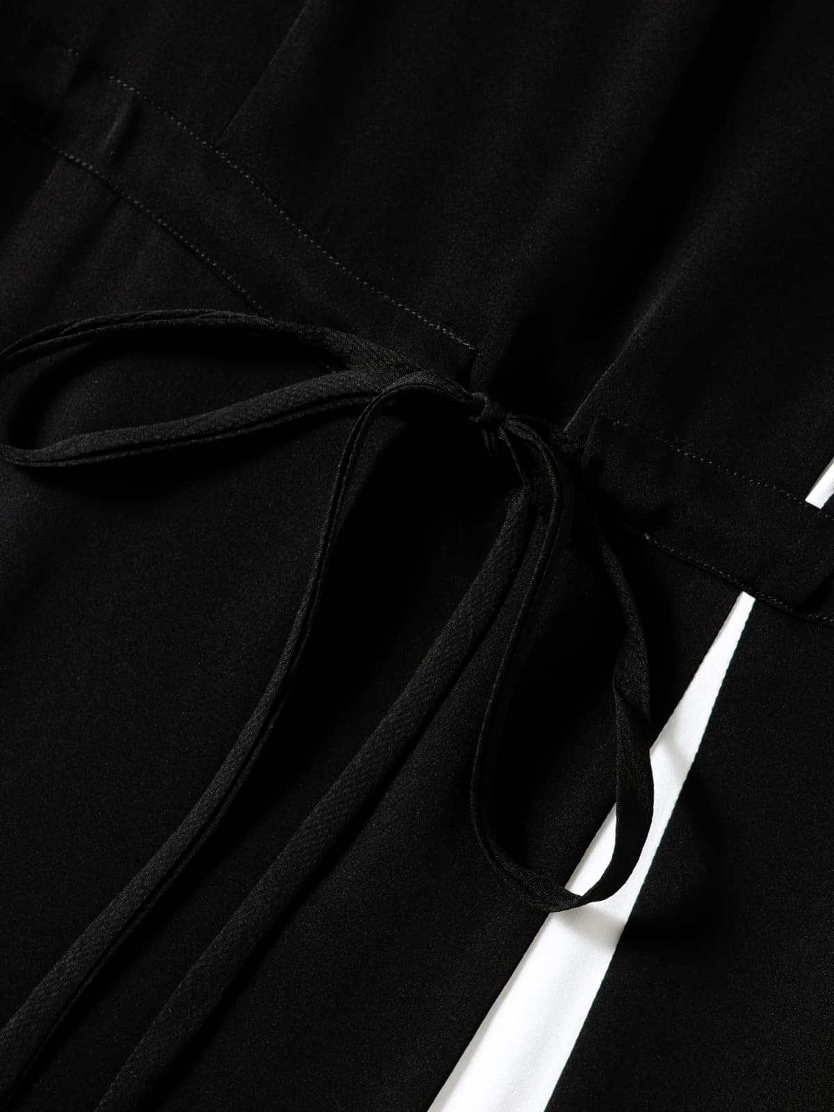 Close-up of Minimalist Black Silk Dress