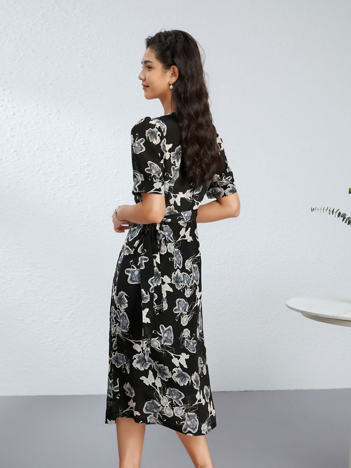 Back view of a model wearing the Chic Floral One - Piece Mulberry Silk Dress with floral design.