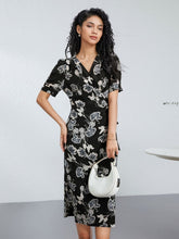 Chic Floral One - Piece Mulberry Silk Dress model wearing a floral patterned dress with a white handbag.