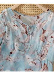 Blue Floral Mulberry Silk Dress close-up showing floral print and ruched waist detailing.