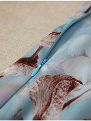 Close-up of the zipper detail on the Blue Floral Mulberry Silk Dress showcasing its elegant design.