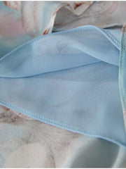 Close-up view of soft blue lining fabric from the Blue Floral Mulberry Silk Dress showcasing smooth texture.