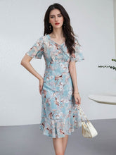 Blue Floral Mulberry Silk Dress featuring a ruched waist and flutter sleeves, perfect for stylish summer occasions.