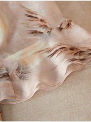 Detail of the hem of a Summer Petite Mulberry Silk Dress featuring elegant floral patterns in soft pastel colors.