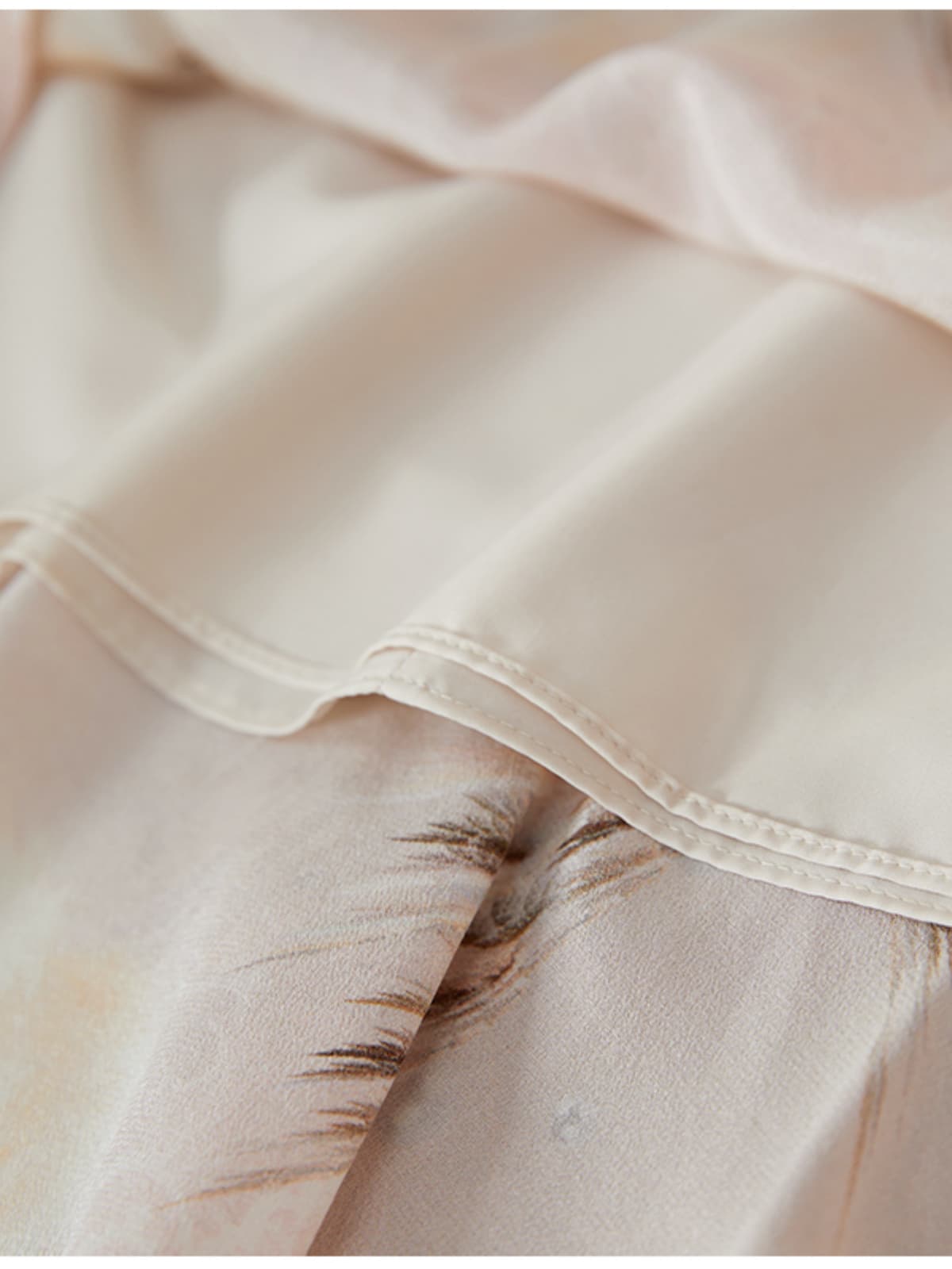 Close-up of the fabric details on the Summer Petite Mulberry Silk Dress showcasing soft silk textures and delicate patterns.