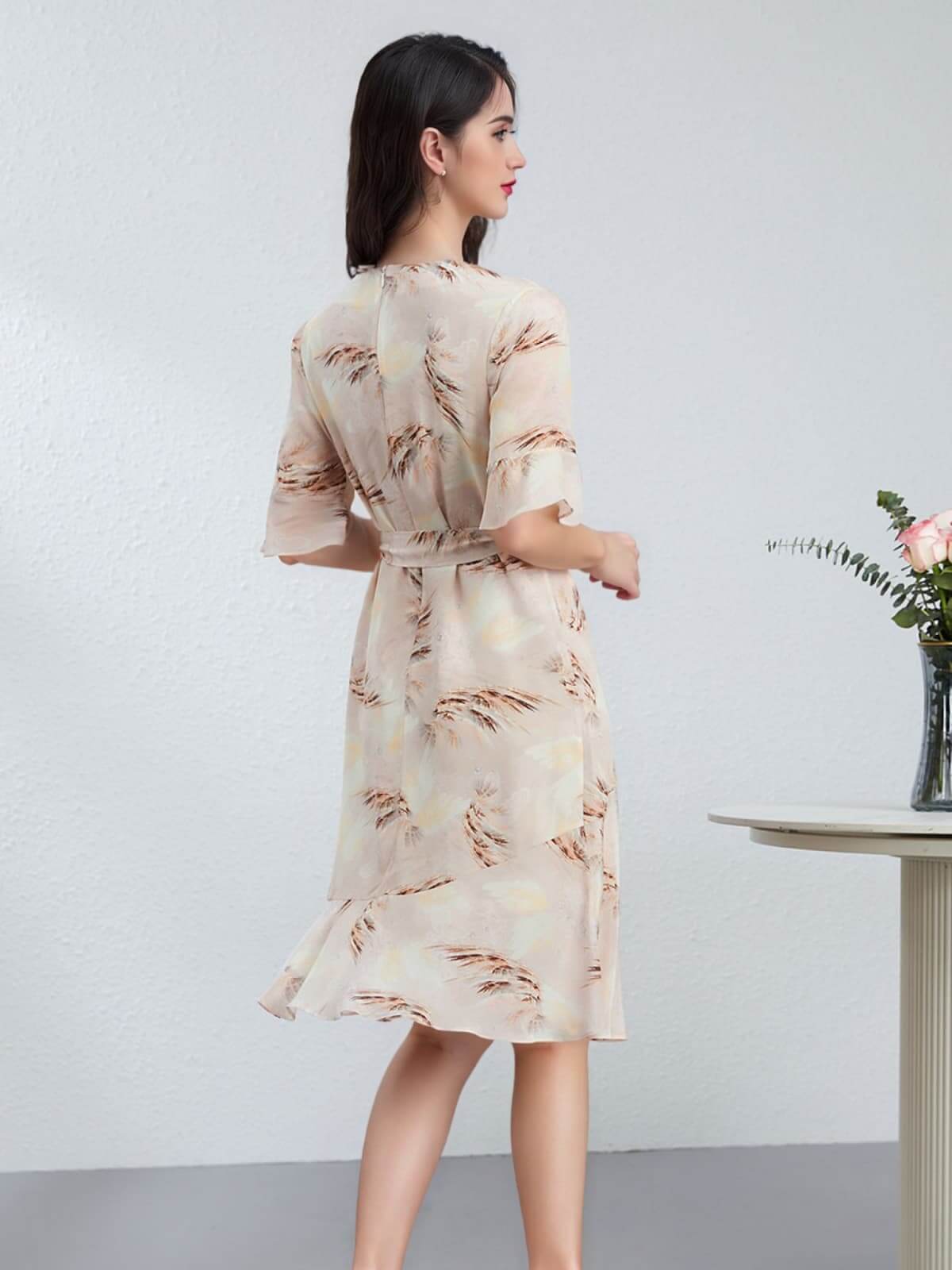 Woman wearing a Summer Petite Mulberry Silk Dress with a flowy design, seen from the back against a neutral background.