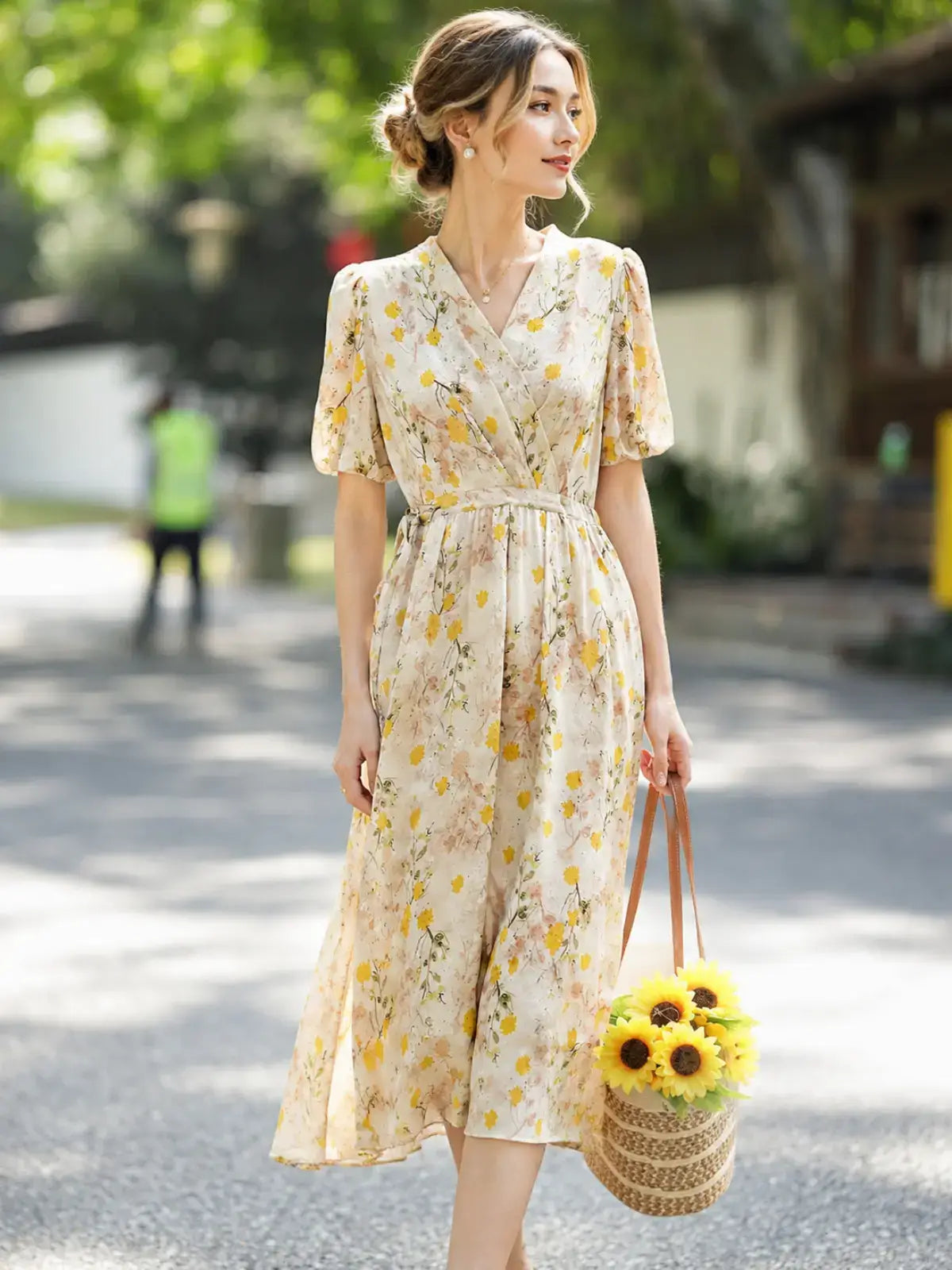 French Floral Mulberry Silk Maxi Dress featuring a woman outdoors in a cream yellow floral design, carrying a sunflowers bag.