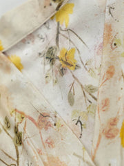 Close-up of the fabric design featuring delicate floral patterns in soft cream yellow on the French Floral Mulberry Silk Maxi Dress.