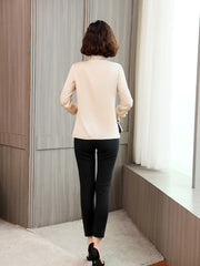 Back view of a woman wearing a Women's Refined Minimalist Silk Blouse with black pants, showcasing sophisticated style.