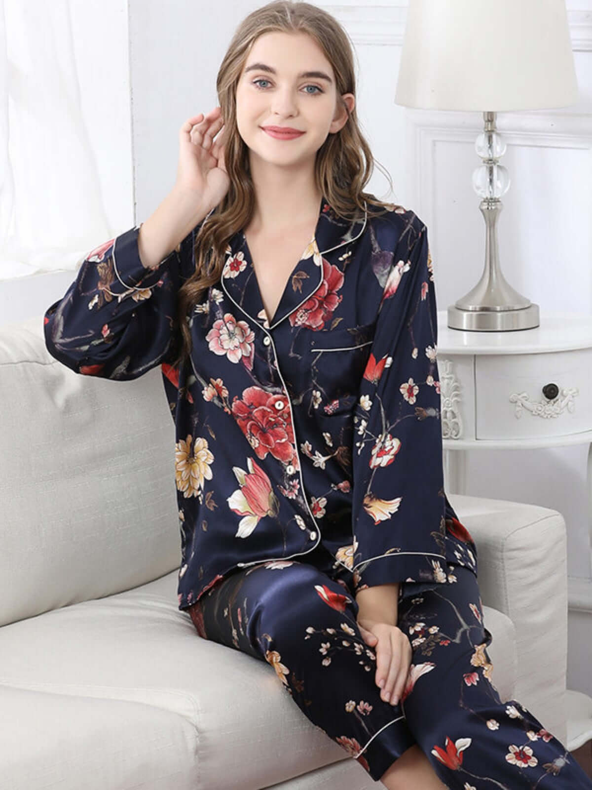 Model wearing Women's Long - sleeved Delicate Floral Silk Pajamas Set sitting on the sofa