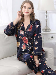 Model wearing Women's Long - sleeved Delicate Floral Silk Pajamas Set sitting on the sofa