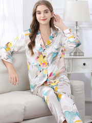 Model wearing Women's Long - sleeved Delicate Floral Silk Pajamas Set in the sitting room