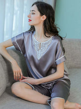 Model wearing Women's Short - sleeved Lace Silk Pajama Set in gray