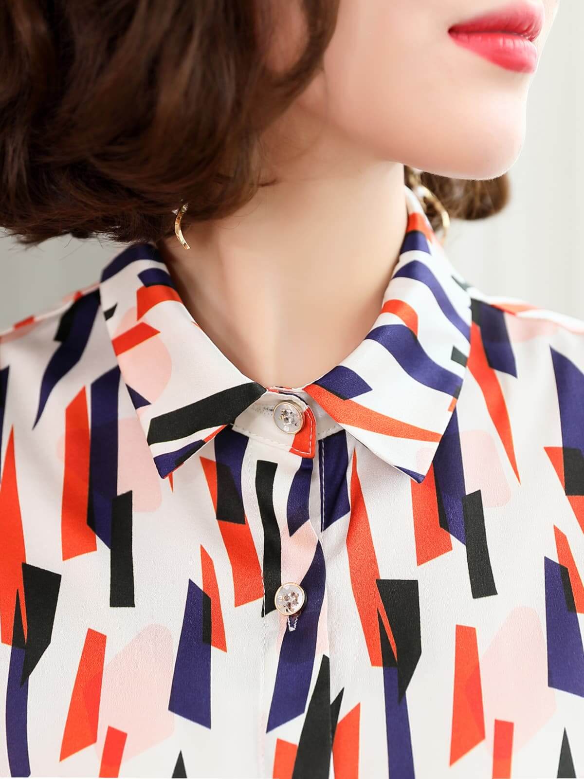 Close-up of Women's Geo - Print Casual Silk Blouse showcasing colorful geometric patterns and stylish collar.