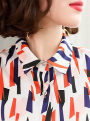 Close-up of Women's Geo - Print Casual Silk Blouse showcasing colorful geometric patterns and stylish collar.