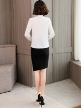 Back view of a woman wearing a Ribbon Tie Mulberry Silk Blouse paired with a black skirt, highlighting elegant style.