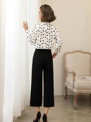 Polka Dot V-neck Mulberry Silk Blouse worn with black pants, showcasing a stylish back view.