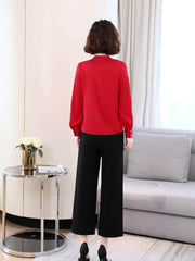 Chic V-neck Silk Blouse in red worn with black pants, stylish for work or weekend outings.