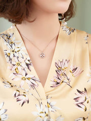 Floral Mulberry Silk Blouse for Women with a delicate floral pattern and a silver necklace worn by a model.