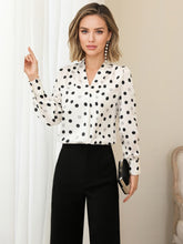 Polka Dot V-neck Mulberry Silk Blouse styled with black pants, featuring a chic look and elegant design.