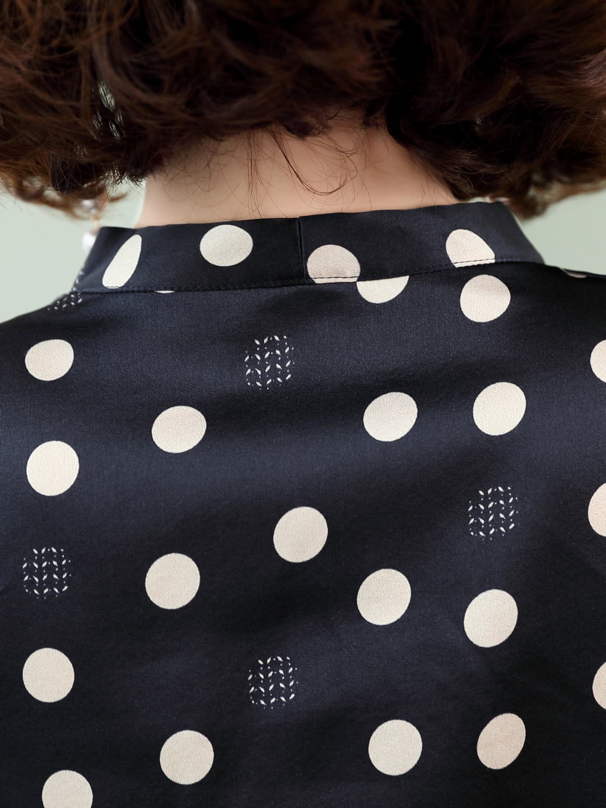 Back view of the Polka Dot V-neck Mulberry Silk Blouse showcasing its elegant polka dot design.