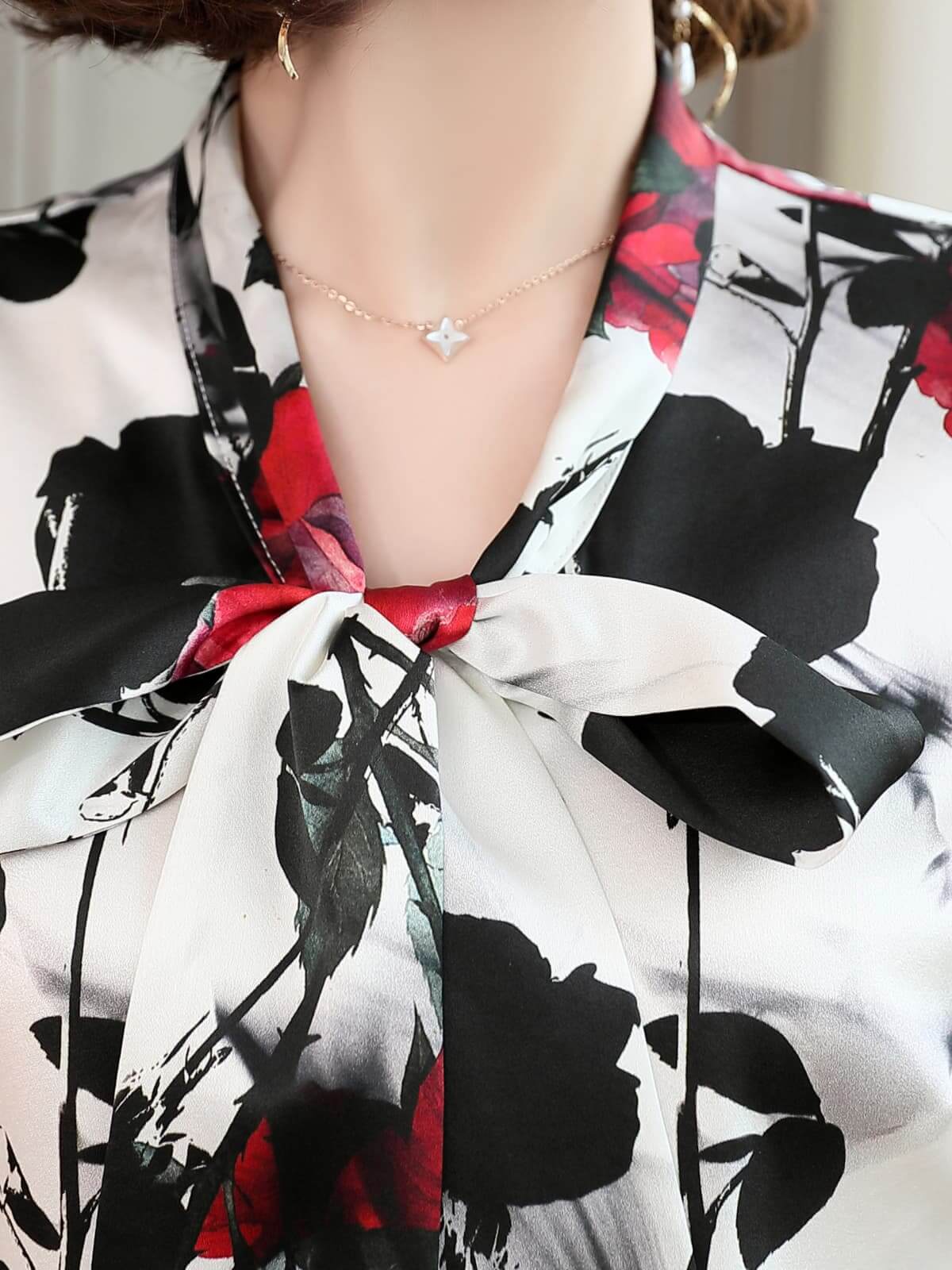 Close-up of the Bow Tie Printed Mulberry Silk Blouse for Women, featuring a floral design and elegant bow tie neckline.