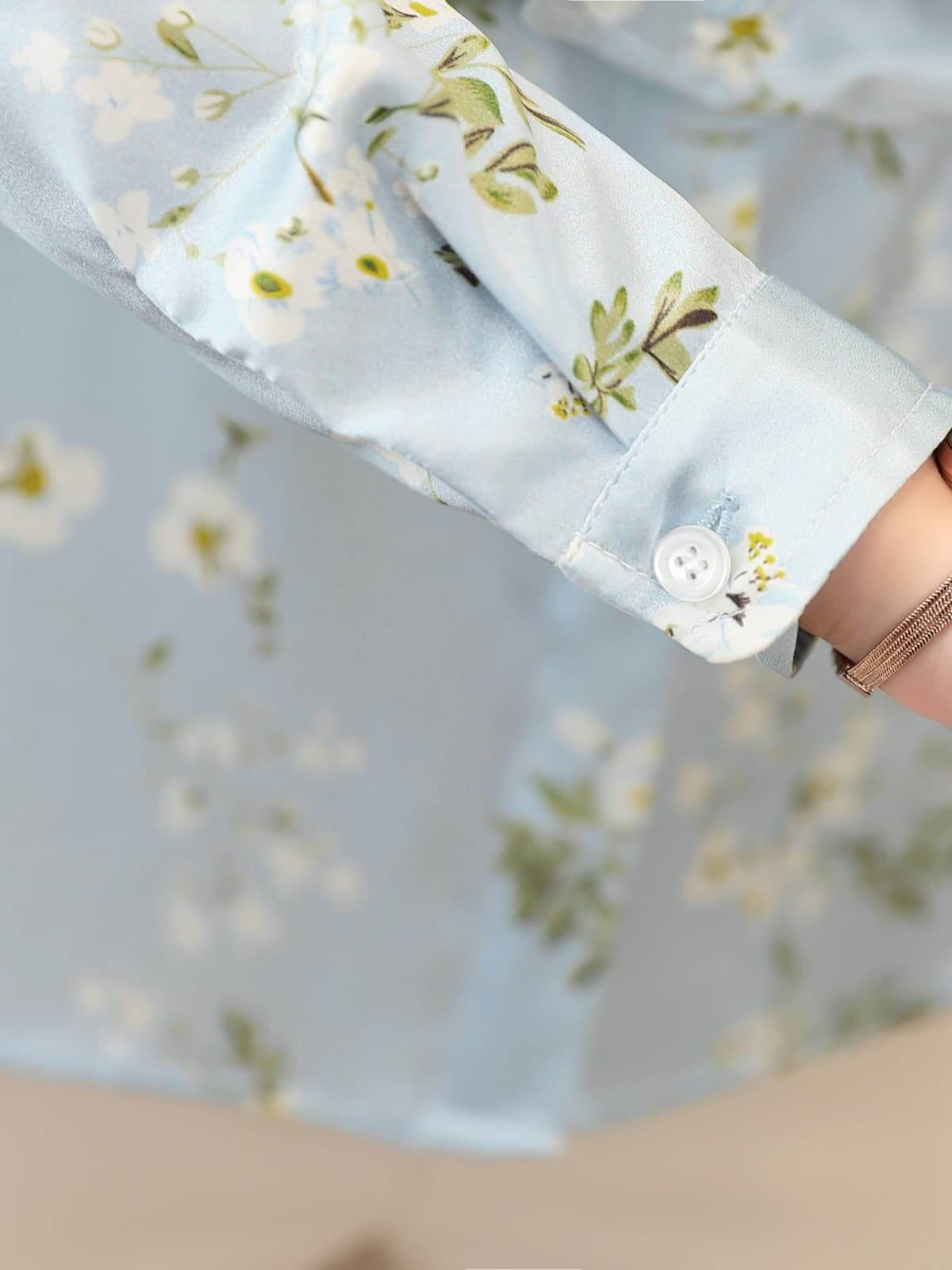 Floral Long Sleeve Mulberry Silk Blouse for Women featuring delicate floral patterns on a light blue fabric.