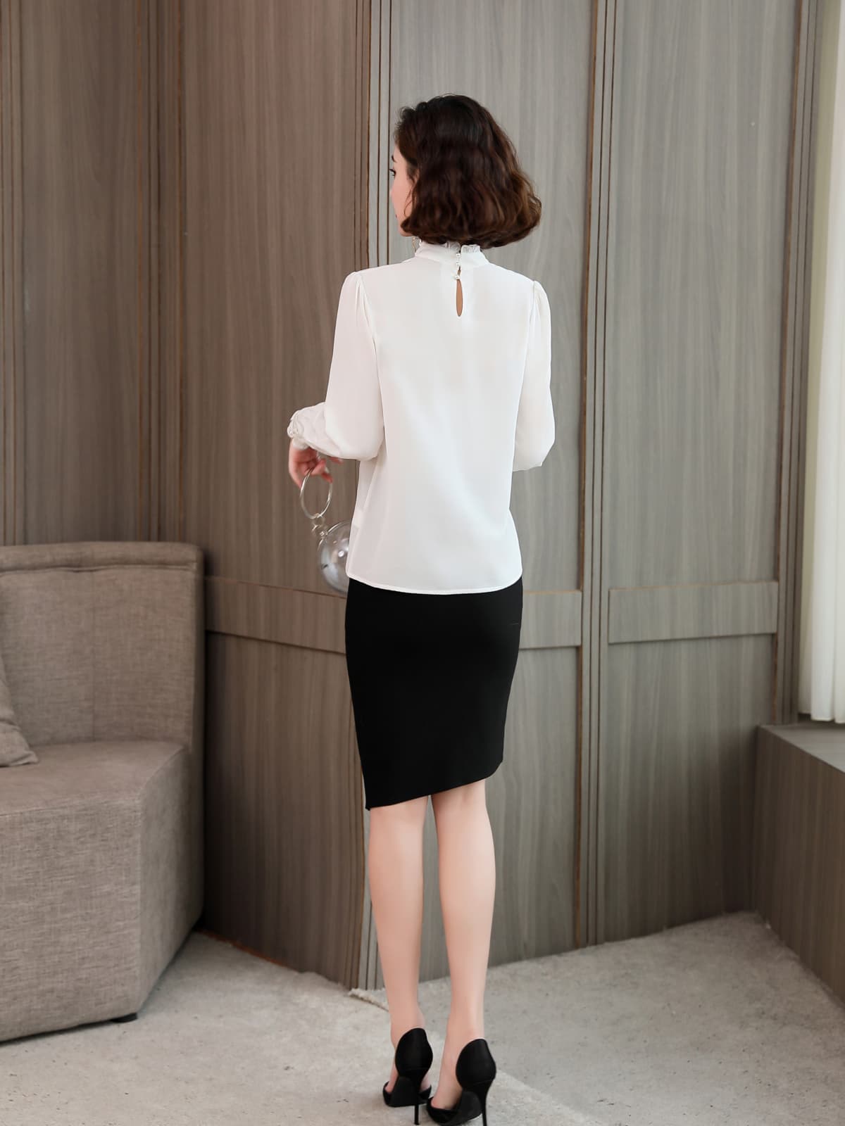 Elegant Lace Collar Silk Blouse for Women, back view, styled with a black skirt and holding a glass.