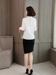 Elegant Lace Collar Silk Blouse for Women, back view, styled with a black skirt and holding a glass.