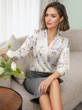 Floral Mulberry Silk Blouse for Women worn by a model sitting on a sofa, showcasing stylish floral patterns.
