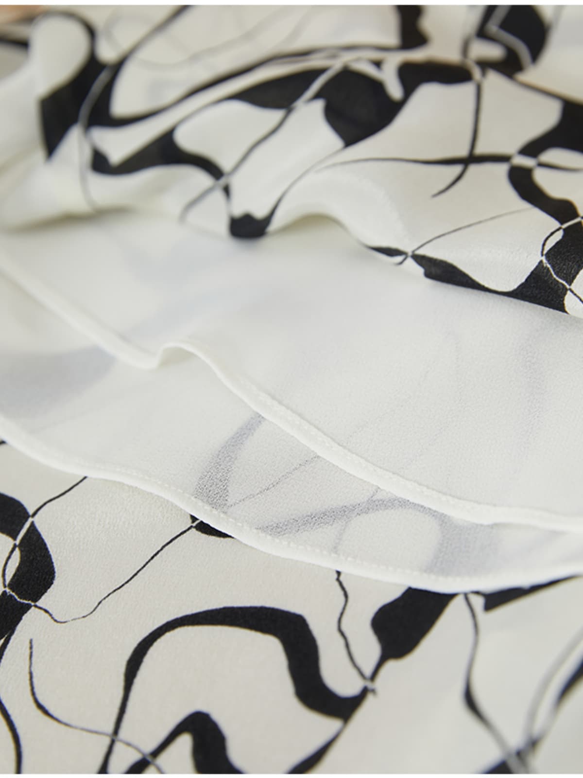 Close-up of fabric texture showcasing design of Breathable Mulberry Silk Shirt Dress with abstract patterns.
