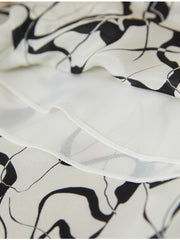 Close-up of fabric texture showcasing design of Breathable Mulberry Silk Shirt Dress with abstract patterns.