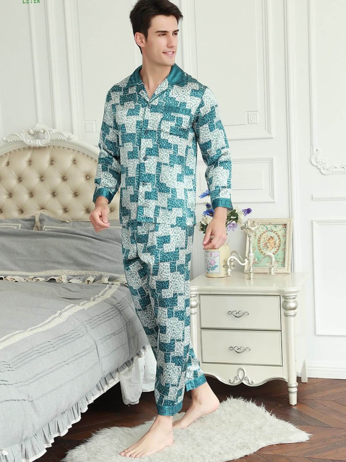 Model wearing stylish short - sleeved men's silk pajamas at home