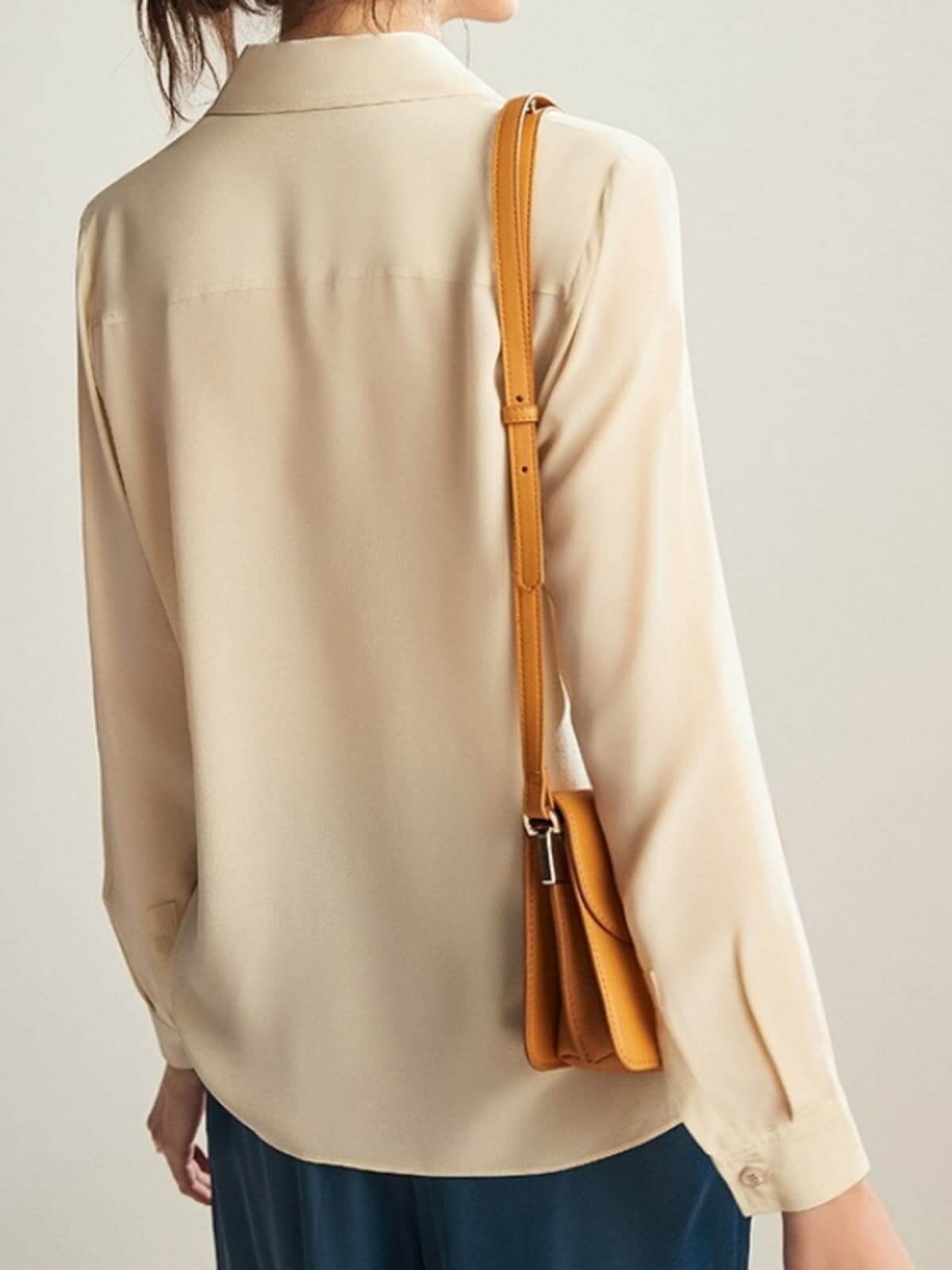 Back view of Embroidered Silk Blouse paired with jeans and bags