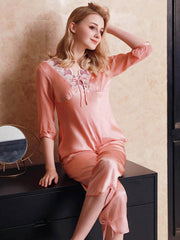 Model sitting on the bench with a Lace Silk Pajama Set for Women