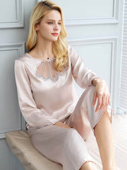 Model wearing Simple Lace Silk Pajama Set for Women Long Sleeves sitting on the sofa
