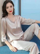 Model wearing Women's Minimalist Silk Pajama Set – Soft Loungewear on the sofa