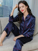 Model wearing Women's Long Sleeve Silk Pajama Set – Soft Sleepwear on the sofa