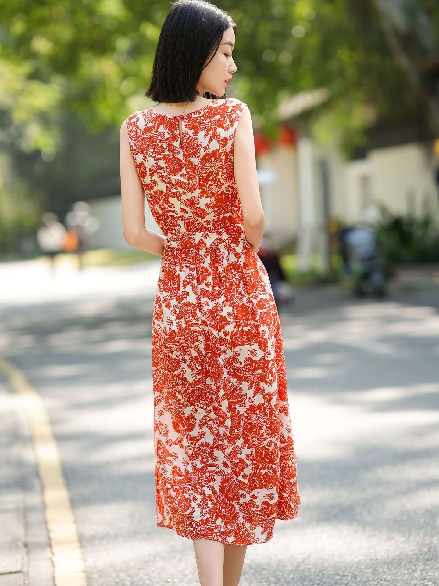 Graceful Mulberry Silk Maxi Dress worn by a woman holding sunflowers in a scenic outdoor setting.
