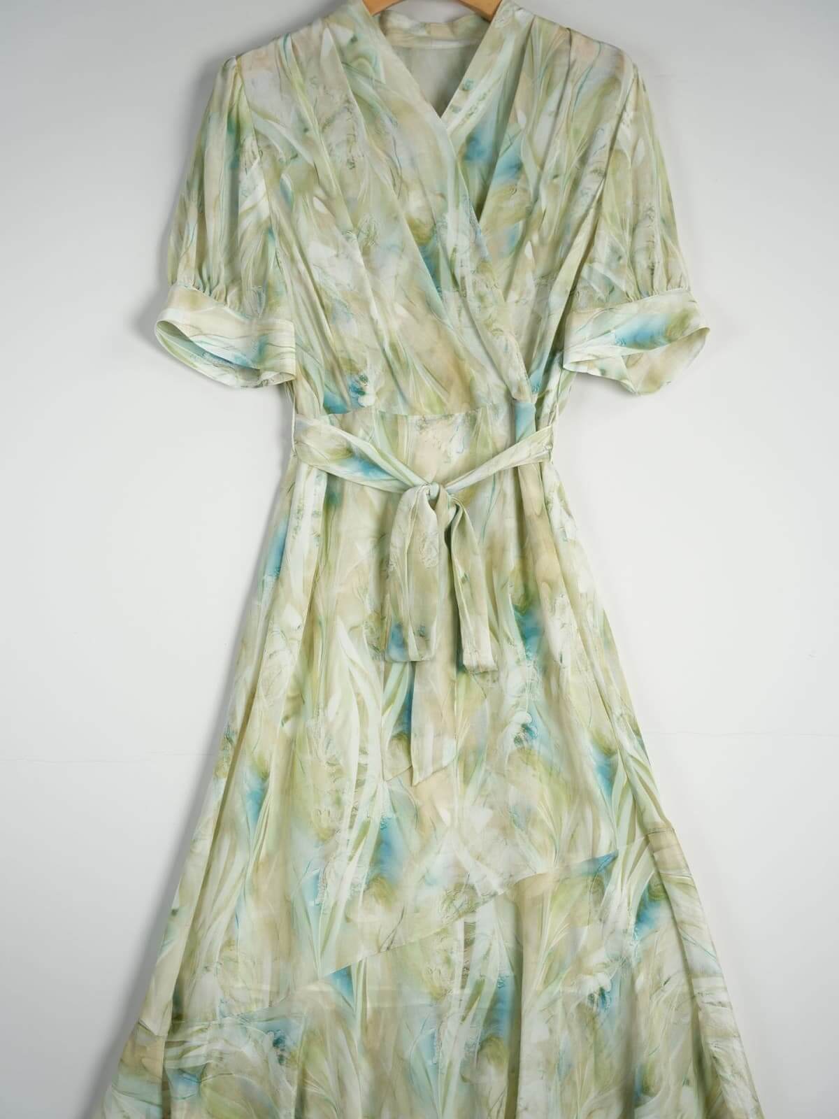 Resort Style Mulberry Silk Dress in light green with blue accents, featuring a wrap design and tie waist.