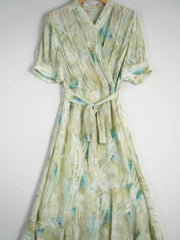 Resort Style Mulberry Silk Dress in light green with blue accents, featuring a wrap design and tie waist.