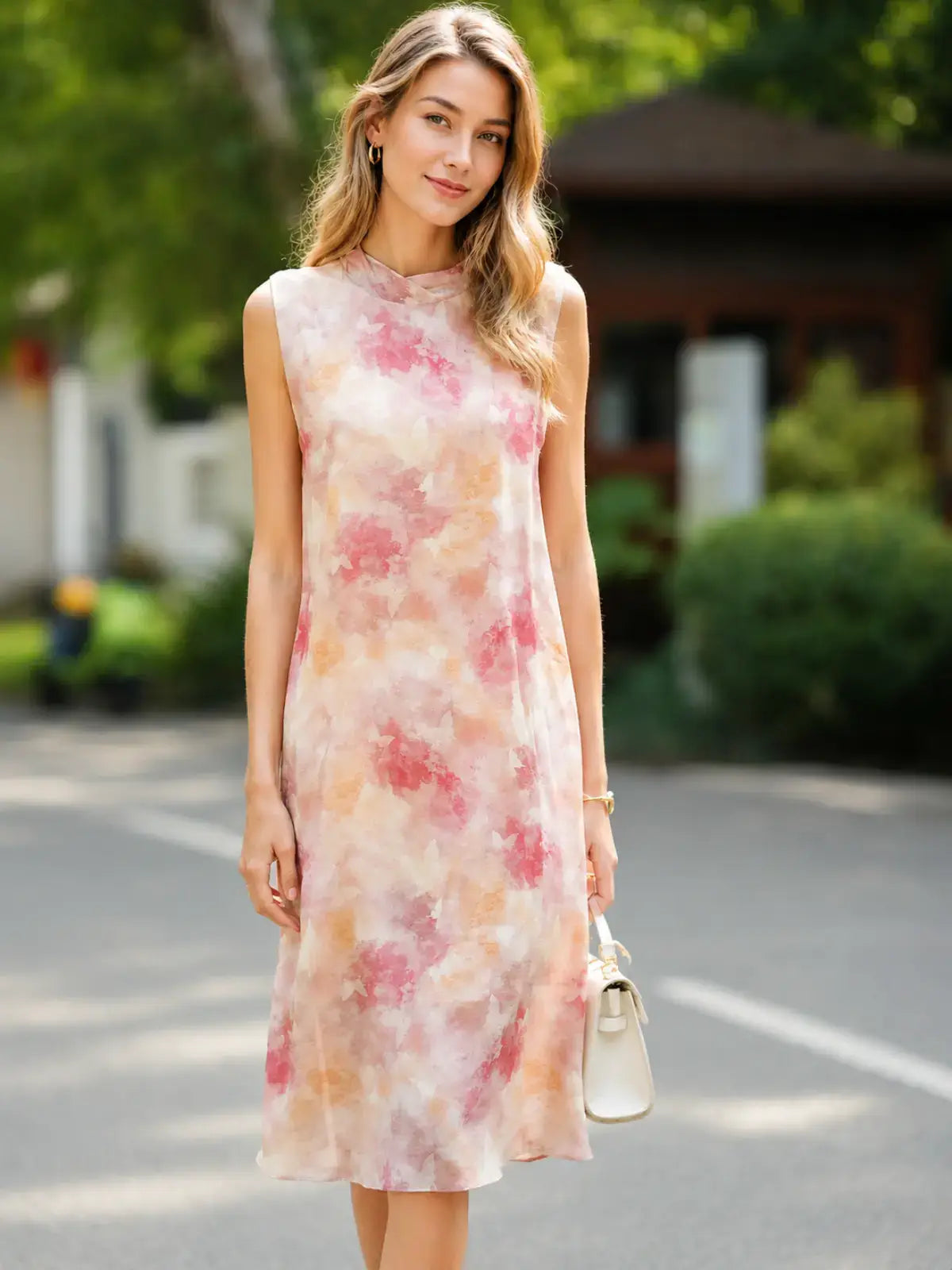 Floral Mulberry Silk Midi Dress worn by a model outdoors, showcasing a soft pastel floral design and elegant silhouette.
