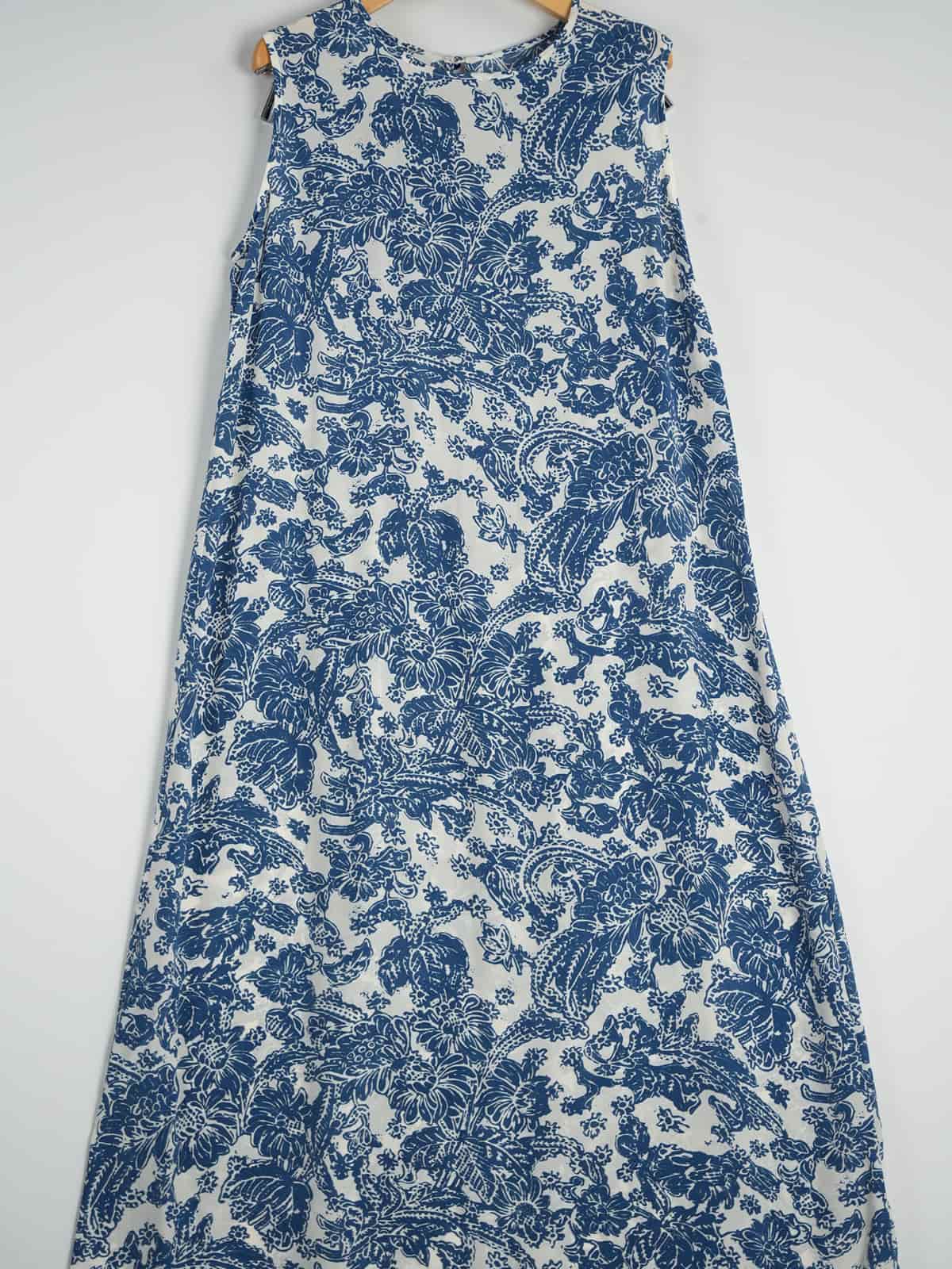 Graceful Mulberry Silk Maxi Dress displayed on a hanger, featuring a blue floral design.