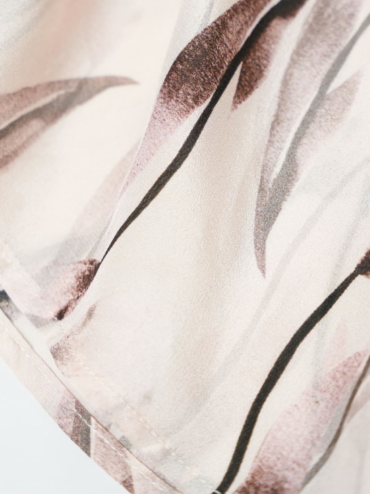Close-up of luxurious fabric showcasing floral patterns, ideal for a Sleeveless Floral Maxi Mulberry Silk Dress.
