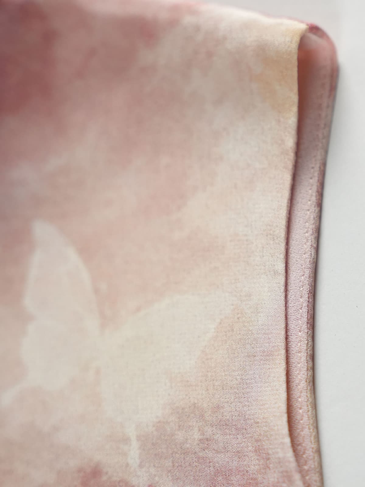 Close-up of the soft texture and delicate butterfly print on the Floral Mulberry Silk Midi Dress.