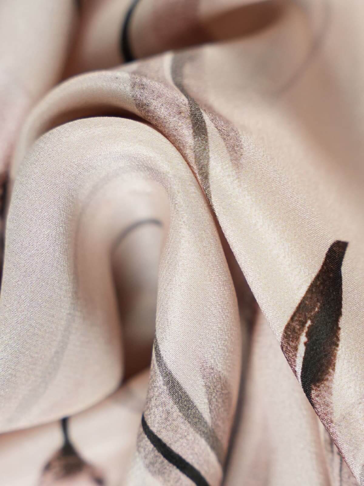 Close-up of luxurious fabric showcasing floral patterns, ideal for a Sleeveless Floral Maxi Mulberry Silk Dress.