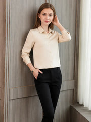 a woman wearing a Women's Refined Minimalist Silk Blouse with black pants, showcasing sophisticated style.