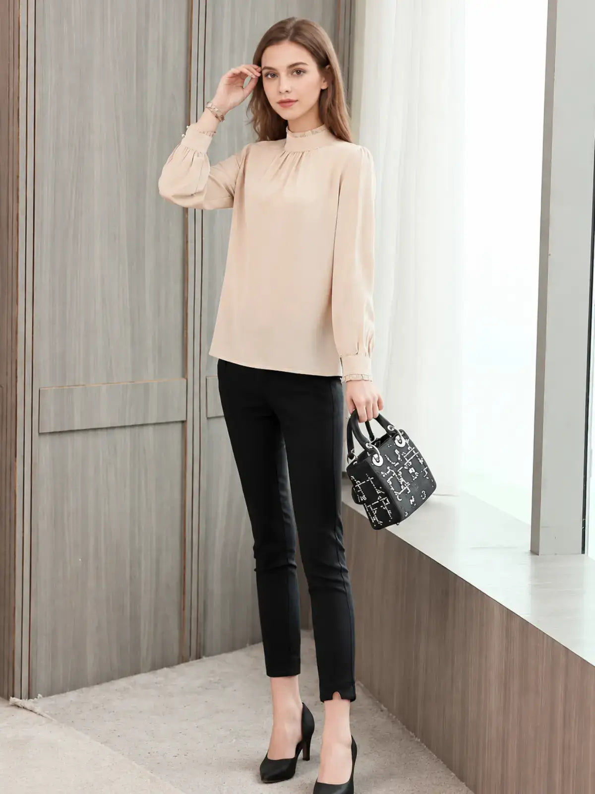 a woman wearing an Elegant Lace Collar Silk Blouse paired with black trousers.