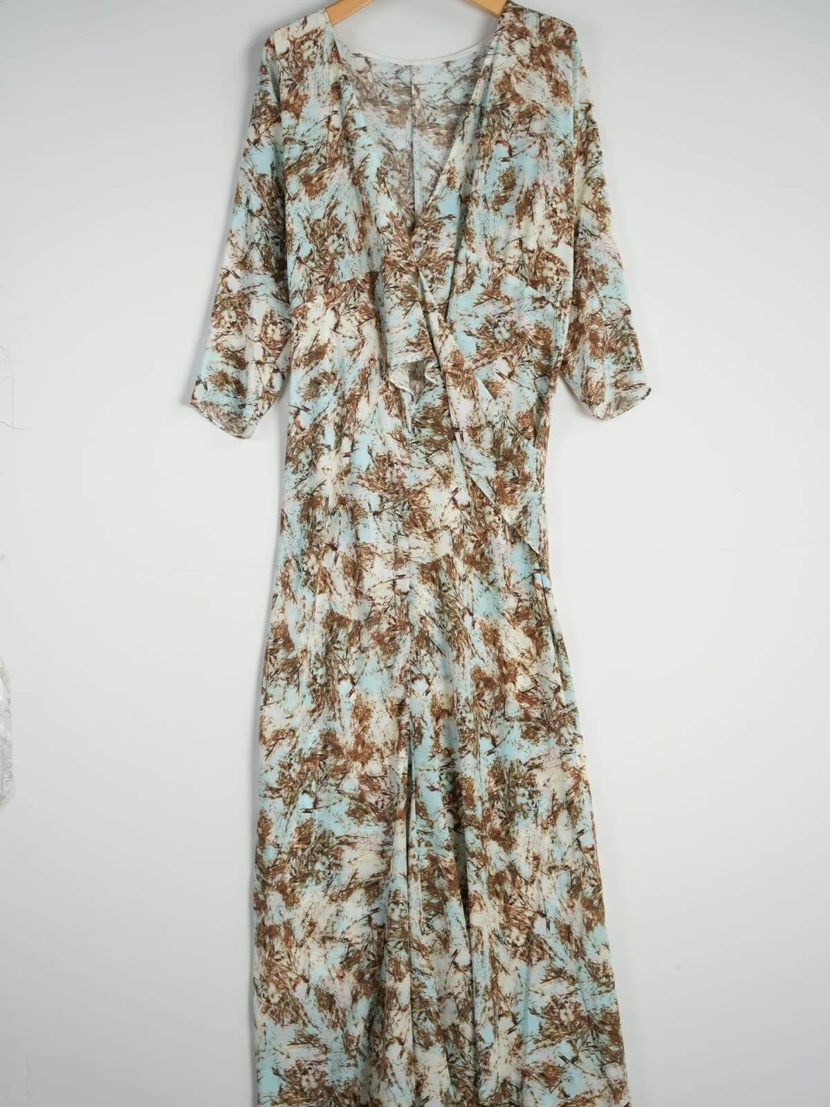 Vintage Print Mulberry Silk Dress displayed on hanger showcasing its unique pattern and flowing design.