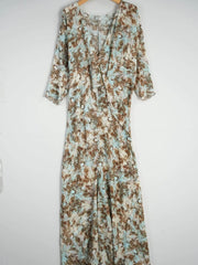 Vintage Print Mulberry Silk Dress displayed on hanger showcasing its unique pattern and flowing design.
